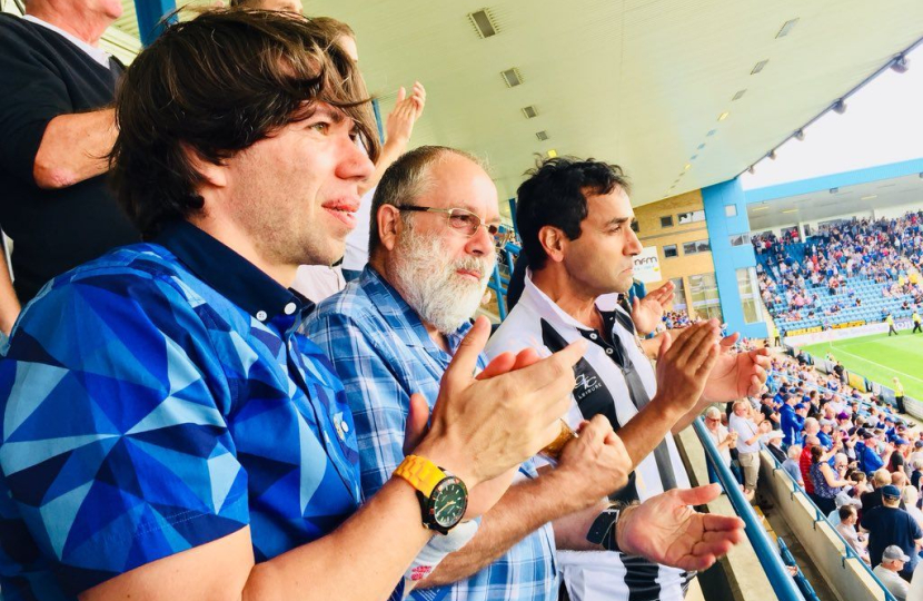 Rehman watching the football with fans