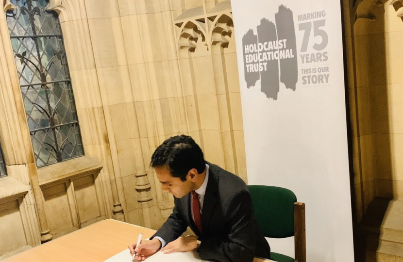 Rehman signing the Book of Commitment