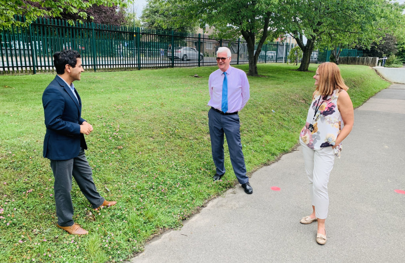 Rehman speaking with staff