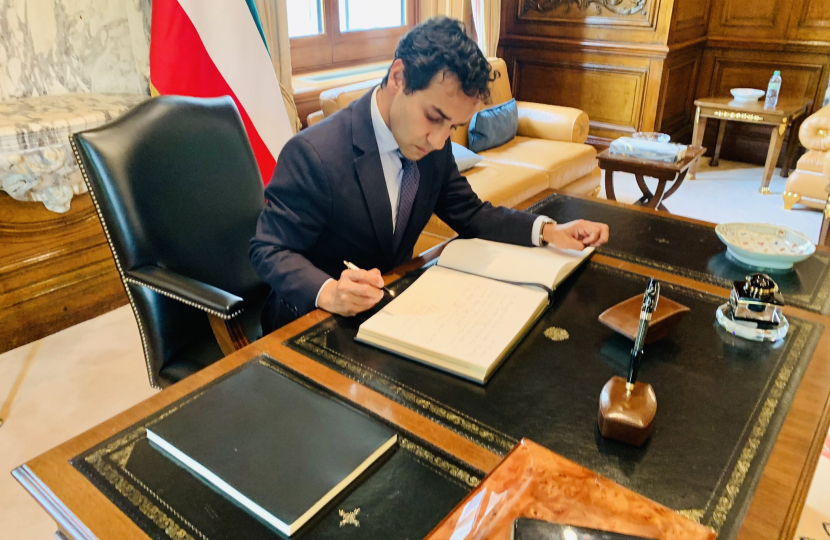 Rehman signing the book of condolences