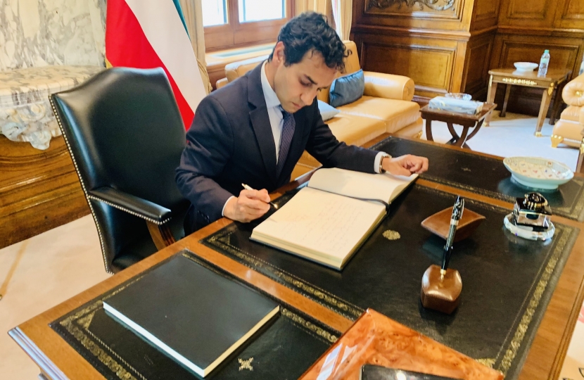 Rehman signing the book of condolences