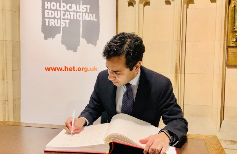 Rehman signing the Book of Commitment