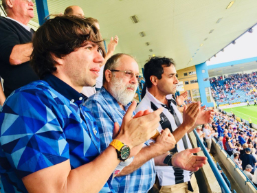 Rehman watching the football with fans