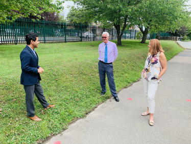 Rehman speaking with staff