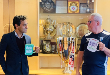 Rehman with Gills Chairman holding Macmillan cut-out mugs