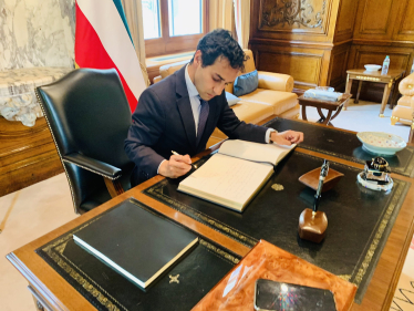 Rehman signing the book of condolences