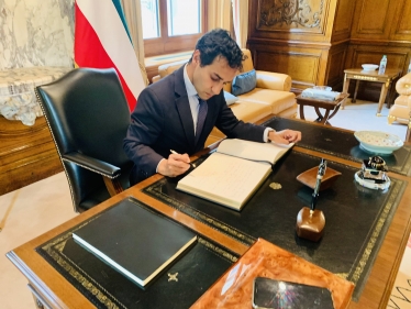 Rehman signing the book of condolences