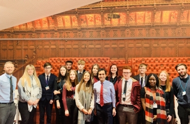 Picture of Rehman with a local school class visiting parliament