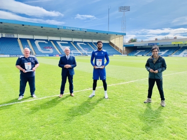 Rehman pictured with Gills FC Manager Steve Evans, Chairman Paul Scally and striker Vadaine Oliver