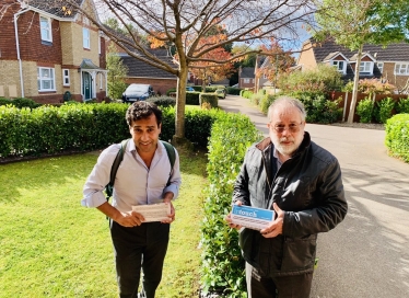 Rehman with Cllr Barrett delivering leaflet