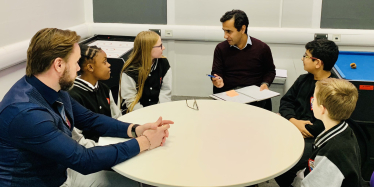 Rehman with school pupils