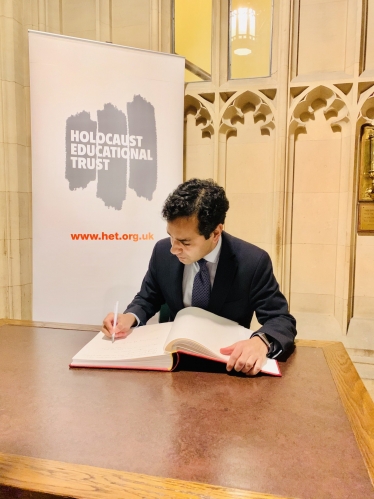 Rehman signing the Book of Commitment